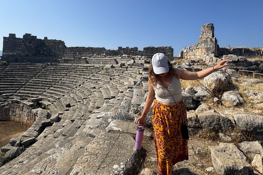 Photobox copywriter Gemma walks among rocks at an amphitheatre in Kalkan, Turkey, illustrating how to choose the right September destination for your holiday.